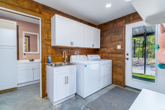 120 Needham Rd, Fountain Lake, AR 71901 - clothes washing area with cabinet space, wood walls, washing machine and dryer, and a sink