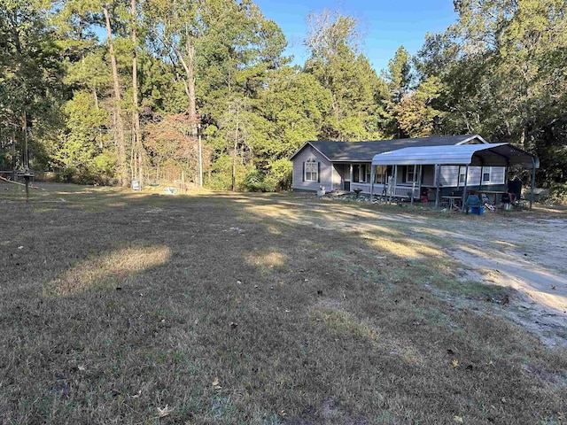 view of front of house with a front lawn, a porch, and a carport