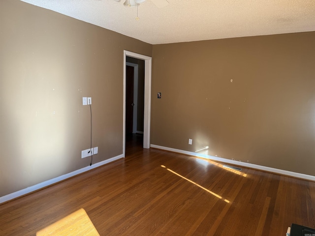 unfurnished room featuring ceiling fan, wood-type flooring, and a textured ceiling