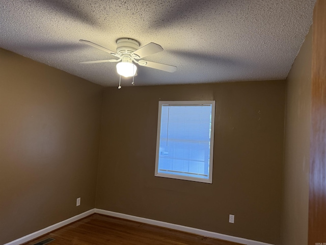 unfurnished room with hardwood / wood-style flooring, ceiling fan, and a textured ceiling