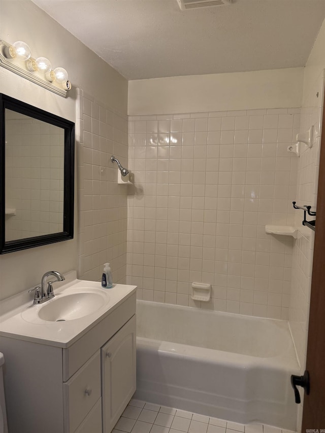 bathroom with tile patterned flooring, vanity, and washtub / shower combination