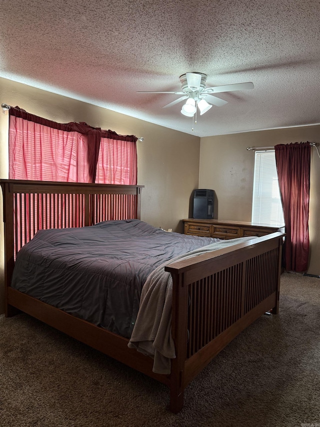 carpeted bedroom featuring a textured ceiling and ceiling fan