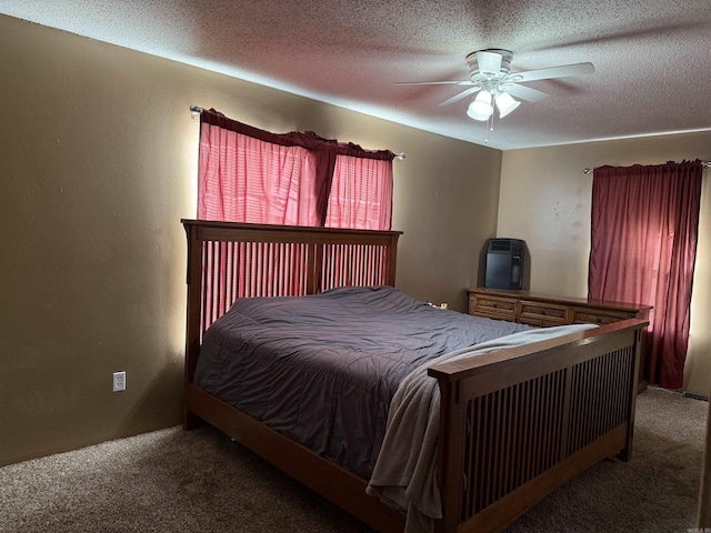 carpeted bedroom with ceiling fan and a textured ceiling