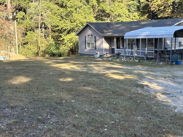 single story home with a carport, covered porch, and a front yard