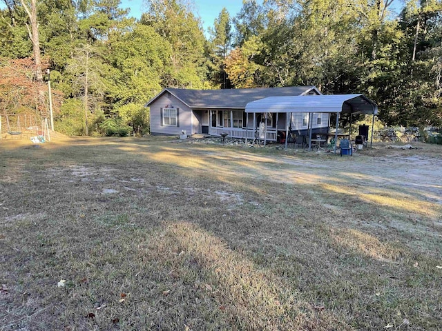 ranch-style house featuring a front yard, a porch, and a carport