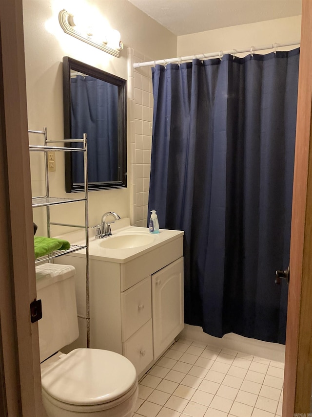 bathroom with tile patterned floors, vanity, toilet, and a shower with curtain