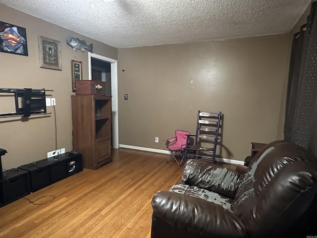 living room featuring a textured ceiling and hardwood / wood-style flooring