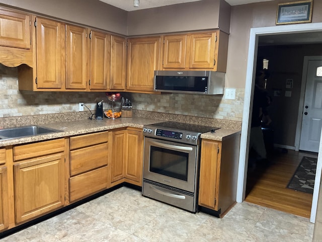 kitchen with backsplash and stainless steel appliances