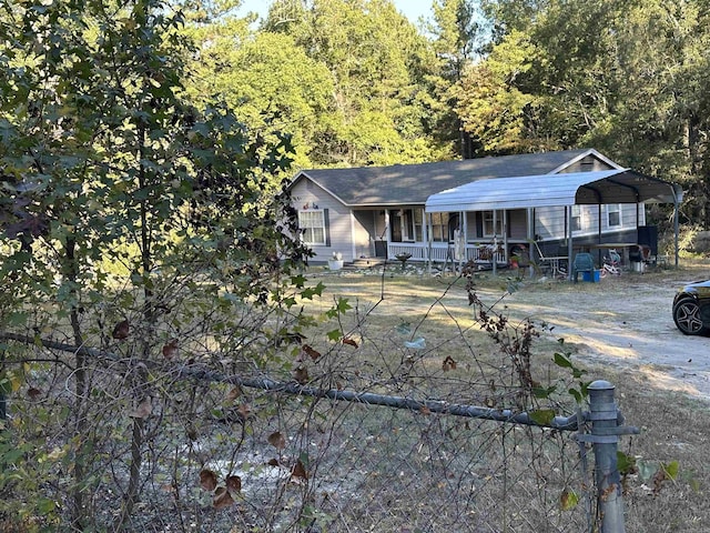 view of front of home featuring a porch and a carport