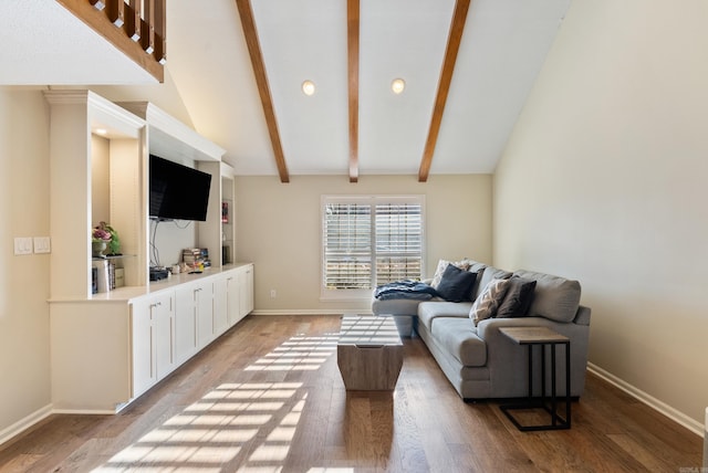 living room featuring lofted ceiling with beams and wood-type flooring