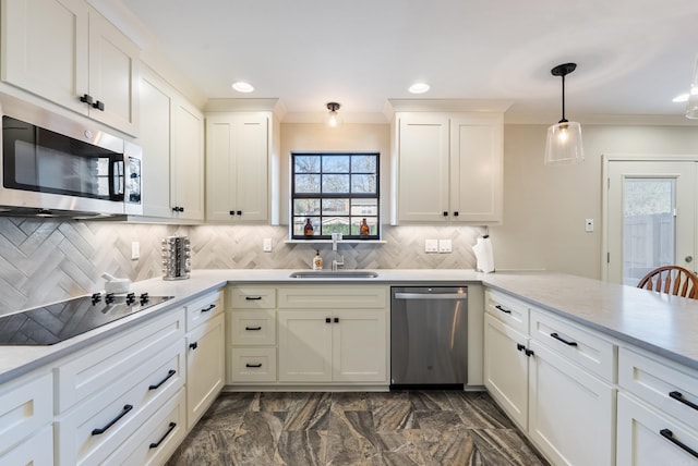 kitchen with sink, kitchen peninsula, decorative light fixtures, decorative backsplash, and appliances with stainless steel finishes