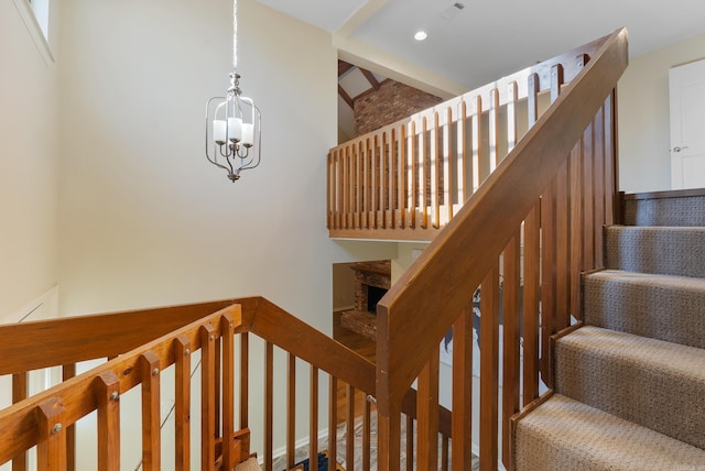 stairway featuring a chandelier