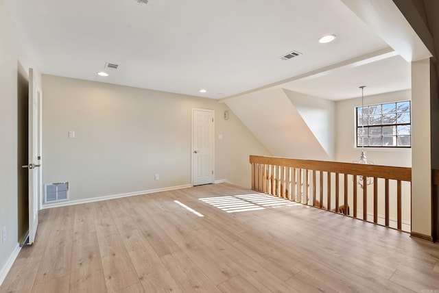 bonus room with lofted ceiling and light hardwood / wood-style flooring