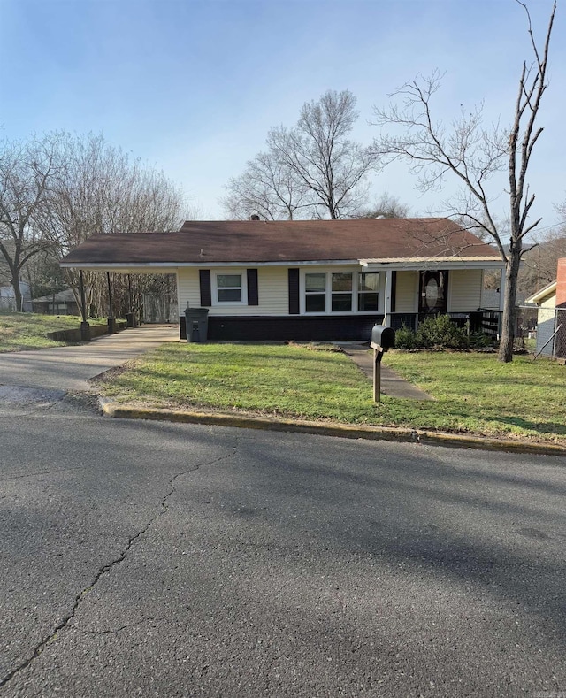 single story home featuring a carport and a front yard