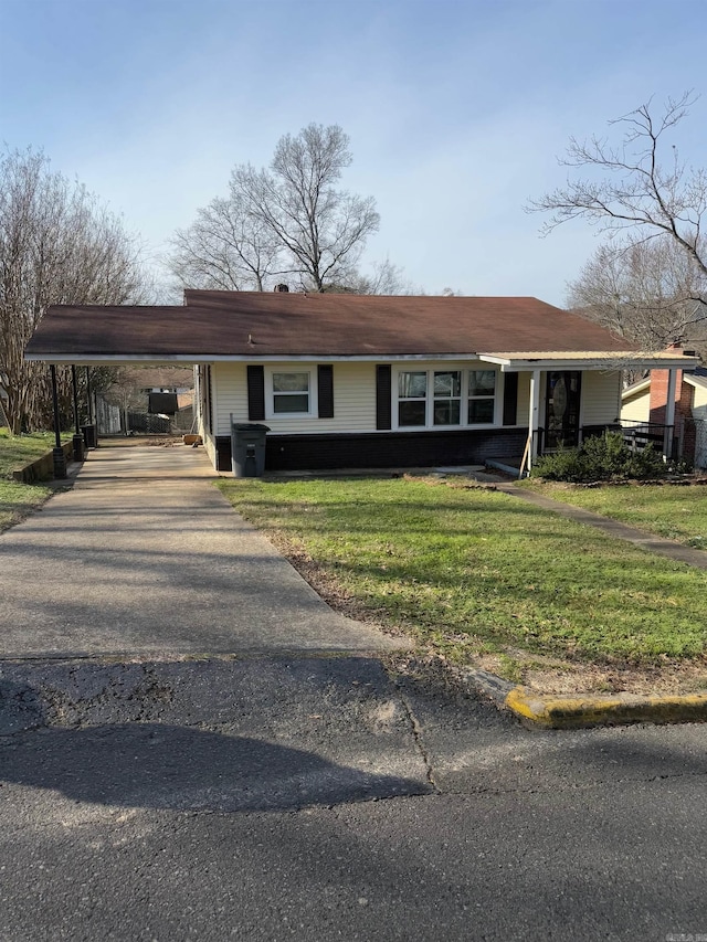 ranch-style home with a front yard and a carport