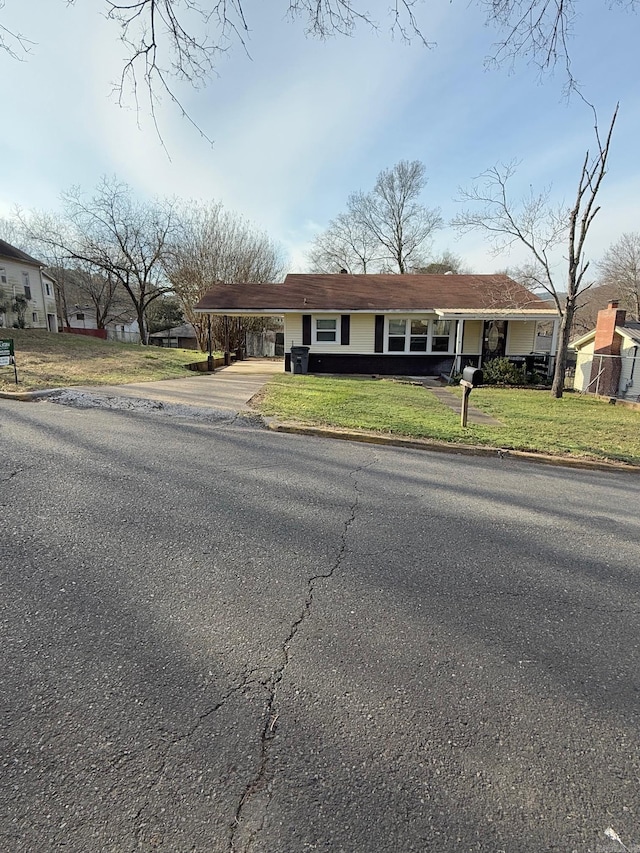 view of front of property with a carport and a front yard