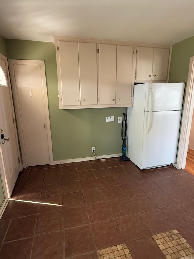 laundry area with dark tile patterned floors