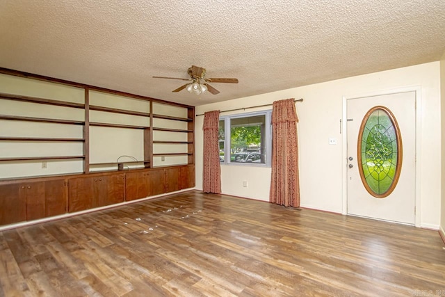 interior space featuring hardwood / wood-style floors, ceiling fan, and a textured ceiling