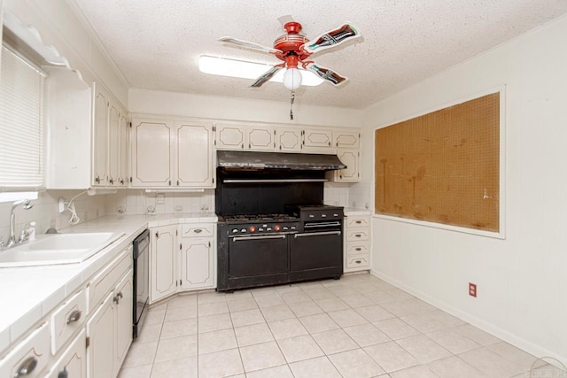 kitchen with decorative backsplash, sink, black appliances, and a textured ceiling