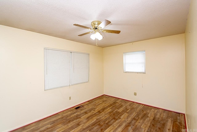 empty room featuring hardwood / wood-style flooring, ceiling fan, and a textured ceiling