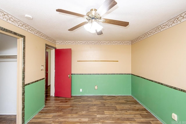 interior space with ceiling fan, a closet, dark hardwood / wood-style floors, and a textured ceiling