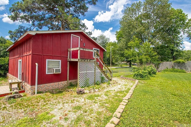 view of outbuilding featuring a lawn