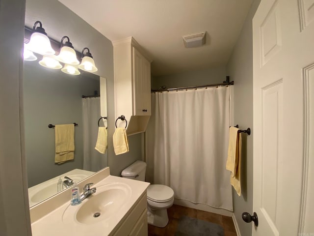 bathroom featuring tile patterned floors, vanity, and toilet