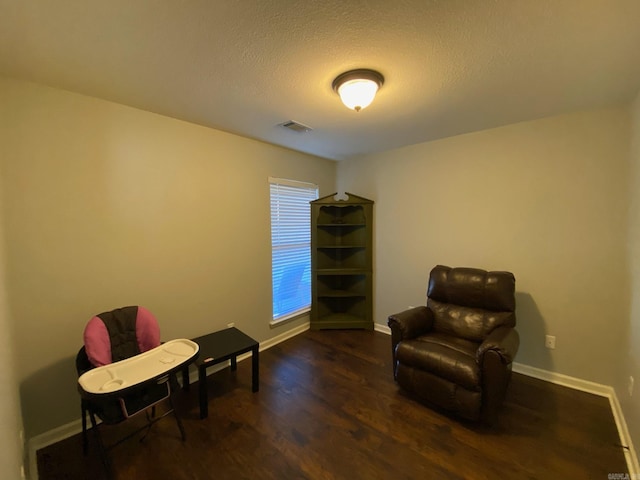 sitting room featuring dark hardwood / wood-style flooring