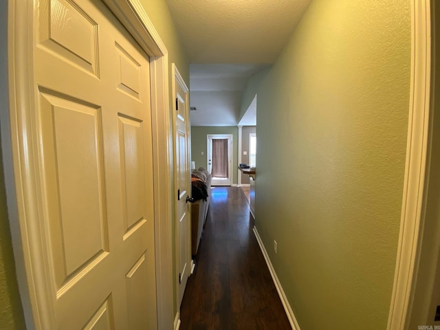 hallway with dark hardwood / wood-style floors