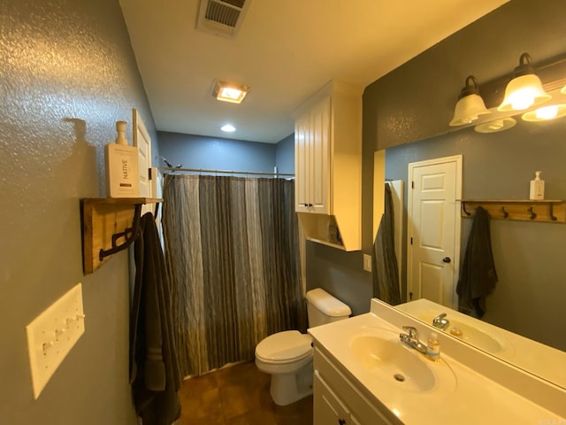 bathroom with vanity, toilet, and walk in shower