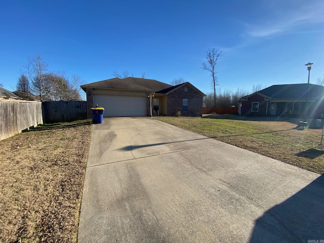 single story home featuring a garage and a front lawn