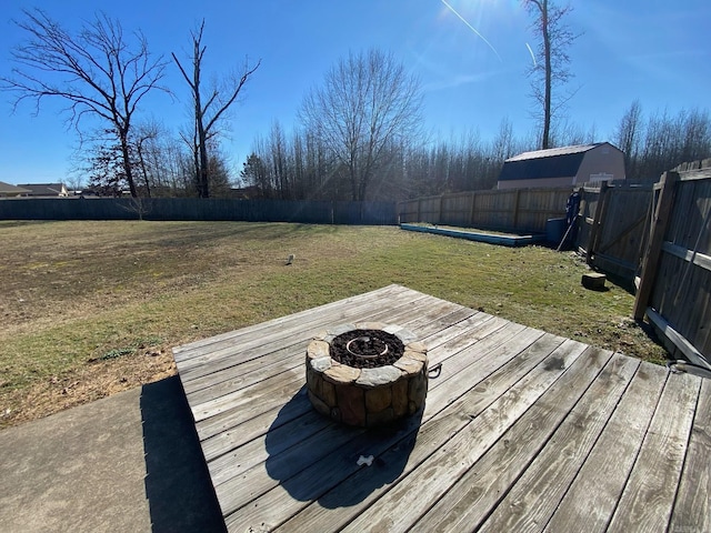 deck with a yard and a fire pit