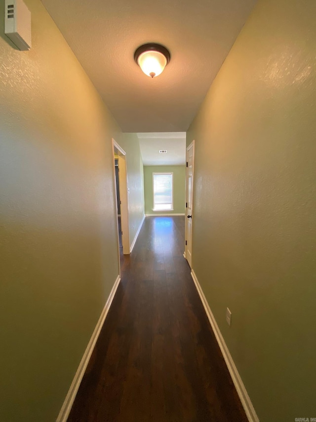 hallway featuring dark wood-type flooring