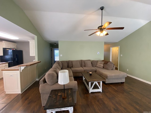 living room featuring ceiling fan, dark hardwood / wood-style floors, and lofted ceiling