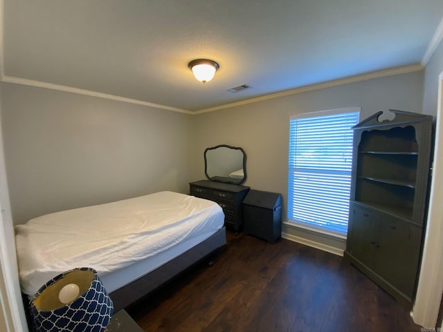 bedroom with crown molding and dark hardwood / wood-style floors