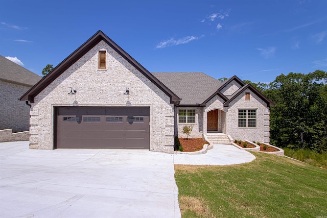 view of front of home featuring a front yard and a garage