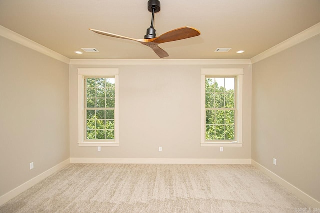 carpeted empty room featuring ceiling fan and ornamental molding