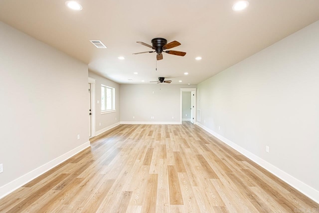 empty room featuring ceiling fan and light hardwood / wood-style flooring