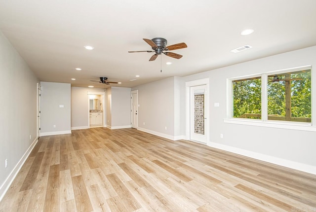 unfurnished living room with light wood-type flooring and ceiling fan