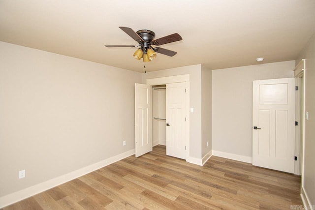 unfurnished bedroom featuring a closet, light hardwood / wood-style floors, and ceiling fan