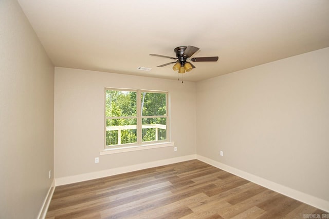 unfurnished room with ceiling fan and light wood-type flooring