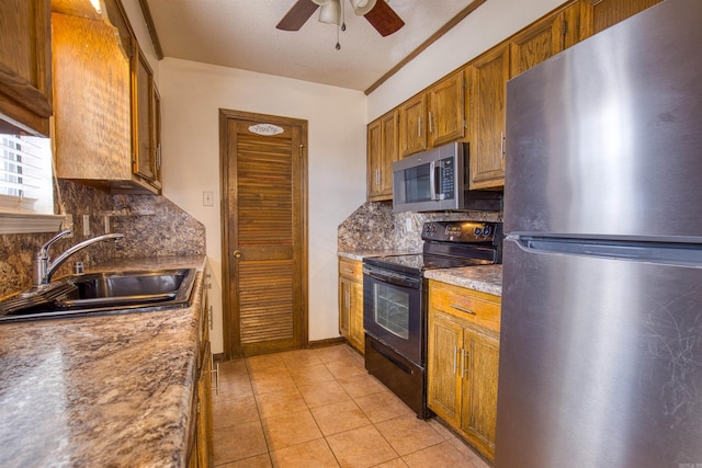 kitchen featuring appliances with stainless steel finishes, backsplash, ceiling fan, and sink