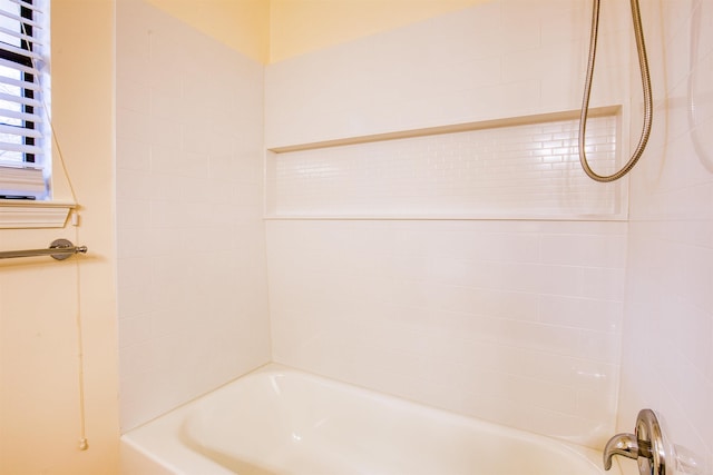 bathroom featuring bathing tub / shower combination and radiator