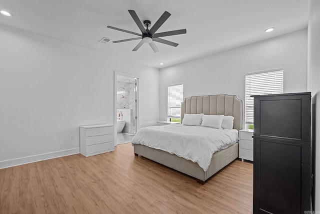 bedroom with ceiling fan, light wood-type flooring, and ensuite bath