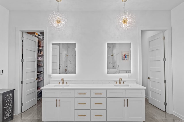 bathroom with walk in shower, vanity, and a notable chandelier