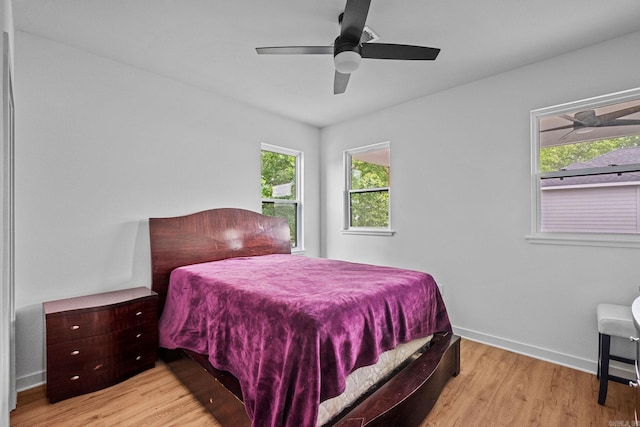 bedroom with light wood-type flooring and ceiling fan