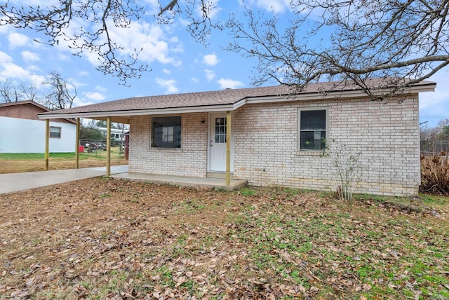 single story home with covered porch and a carport