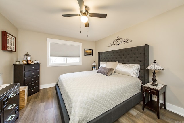 bedroom featuring ceiling fan and dark hardwood / wood-style flooring