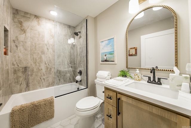 full bathroom featuring toilet, vanity, and tiled shower / bath