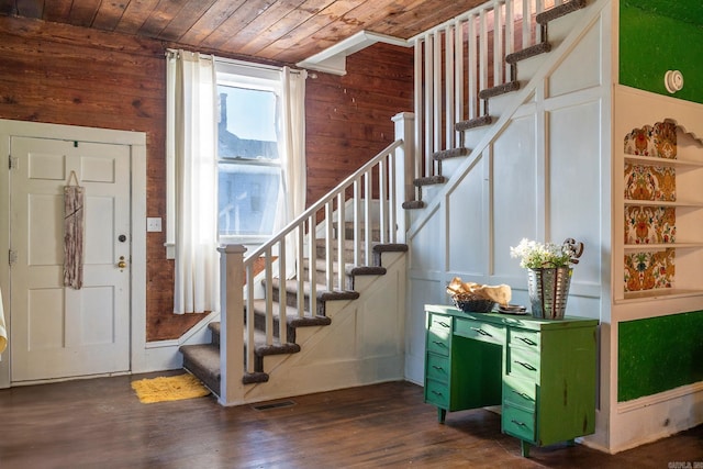 foyer featuring dark wood-type flooring and wood ceiling